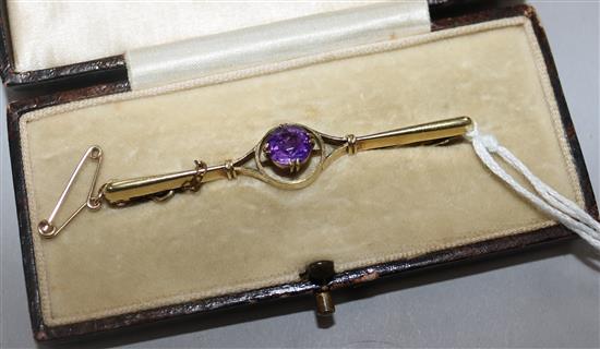 An early 20th century 15ct gold and amethyst bar brooch, 56mm.